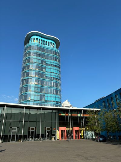 The glass tower of the building, where the camp took place in front of a perfect blue sky